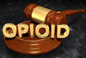 A judge's gavel and stand, with the word "opioid" across them