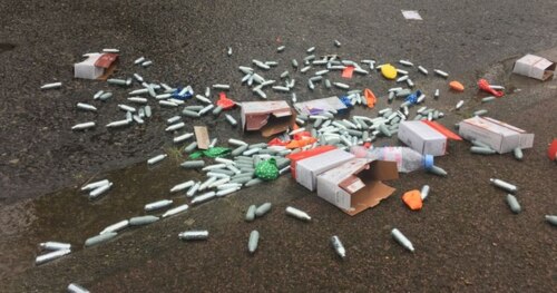 empty N2O chargers, deflated balloons, and other refuse scattered on pavement