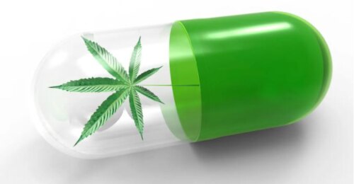 A medication capsule with one end green and the other clear, with a cannabis leaf inside.