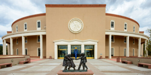 view of the main entrance of the new mexico state capitol building with sculpture in foreground