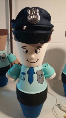 Figure of a police officer made from painted flower pots.